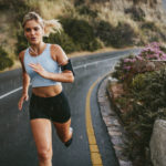 Female athlete running outdoors on highway