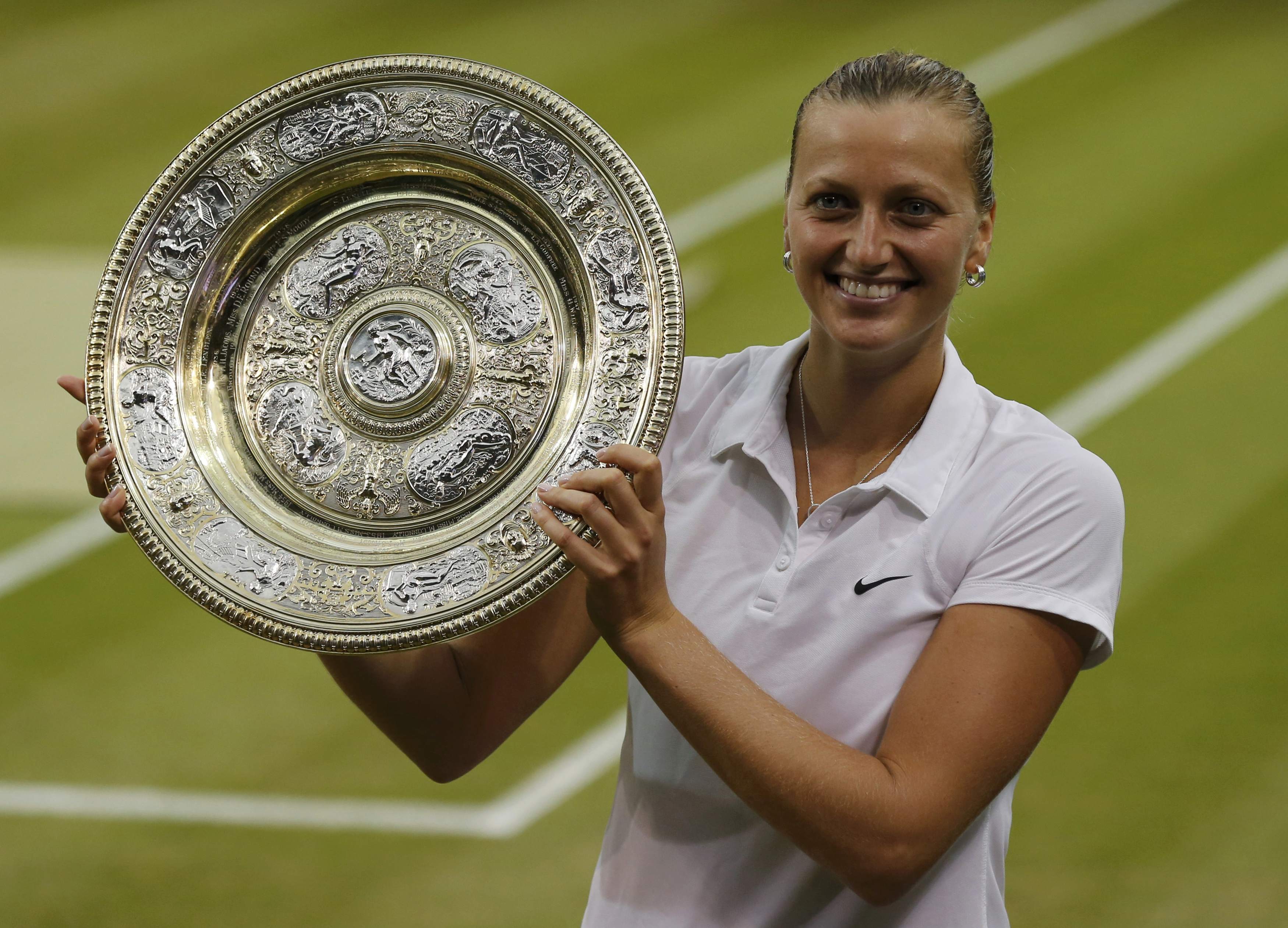Kvitova of the Czech Republic holds the winner's trophy after defeating